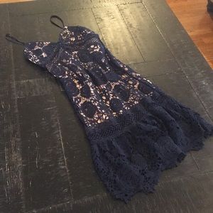 Nude and navy lace overlay cocktail dress